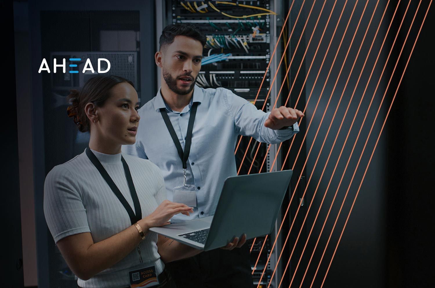 people looking at a computer and pointing to hardware