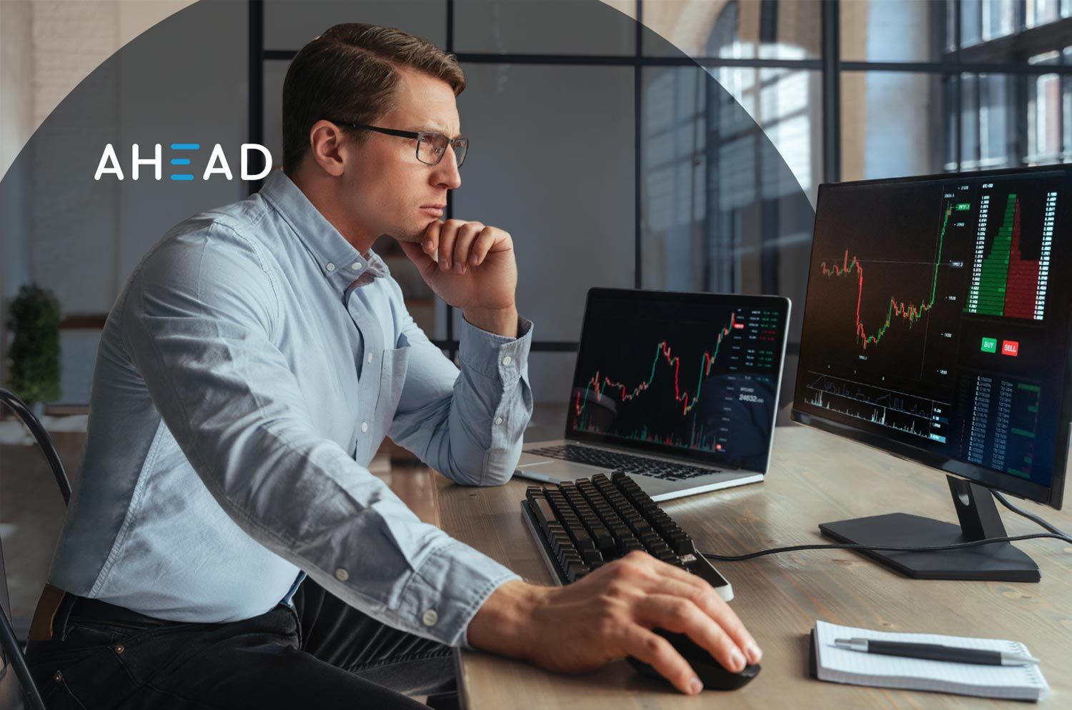 man on computer looking at charts