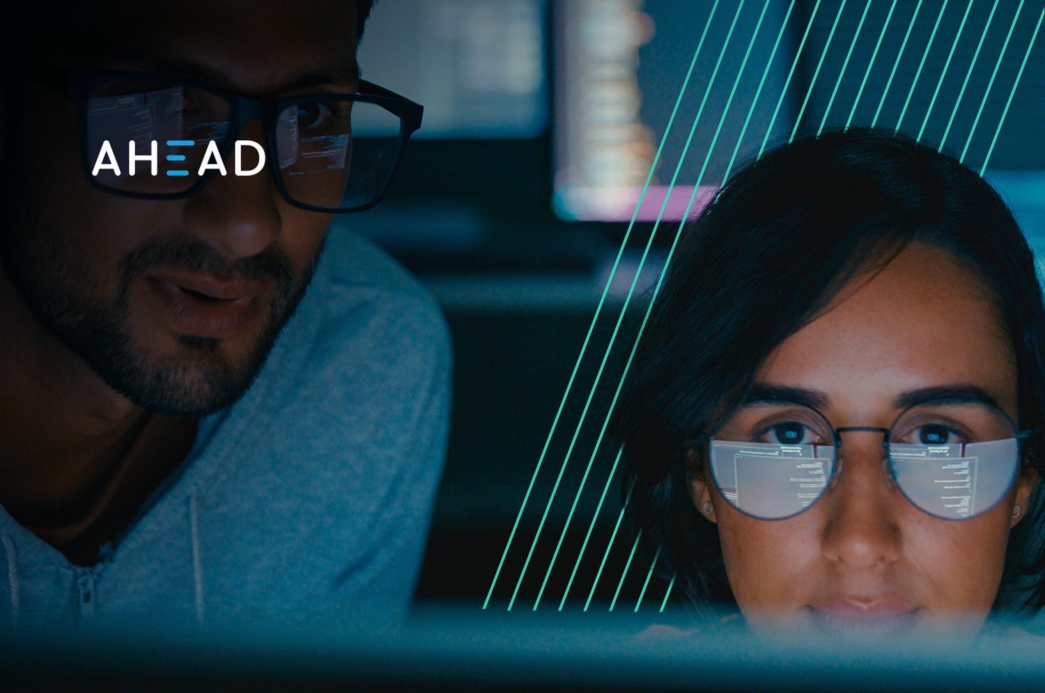man and woman looking at computer screen
