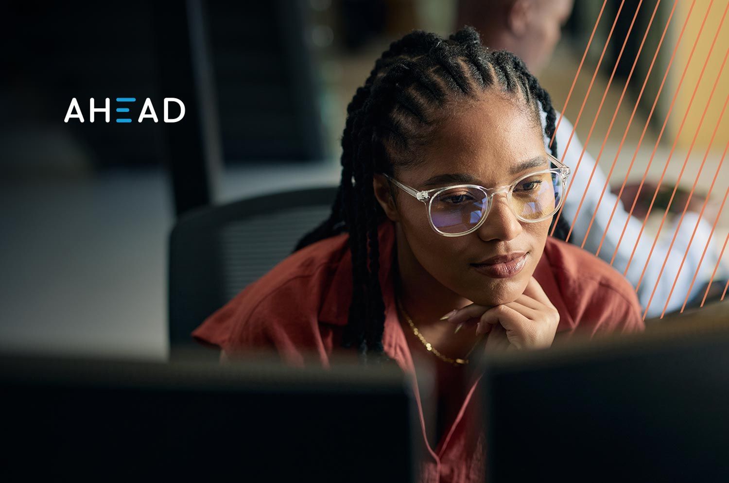 woman staring at computer with technology graphics in the background