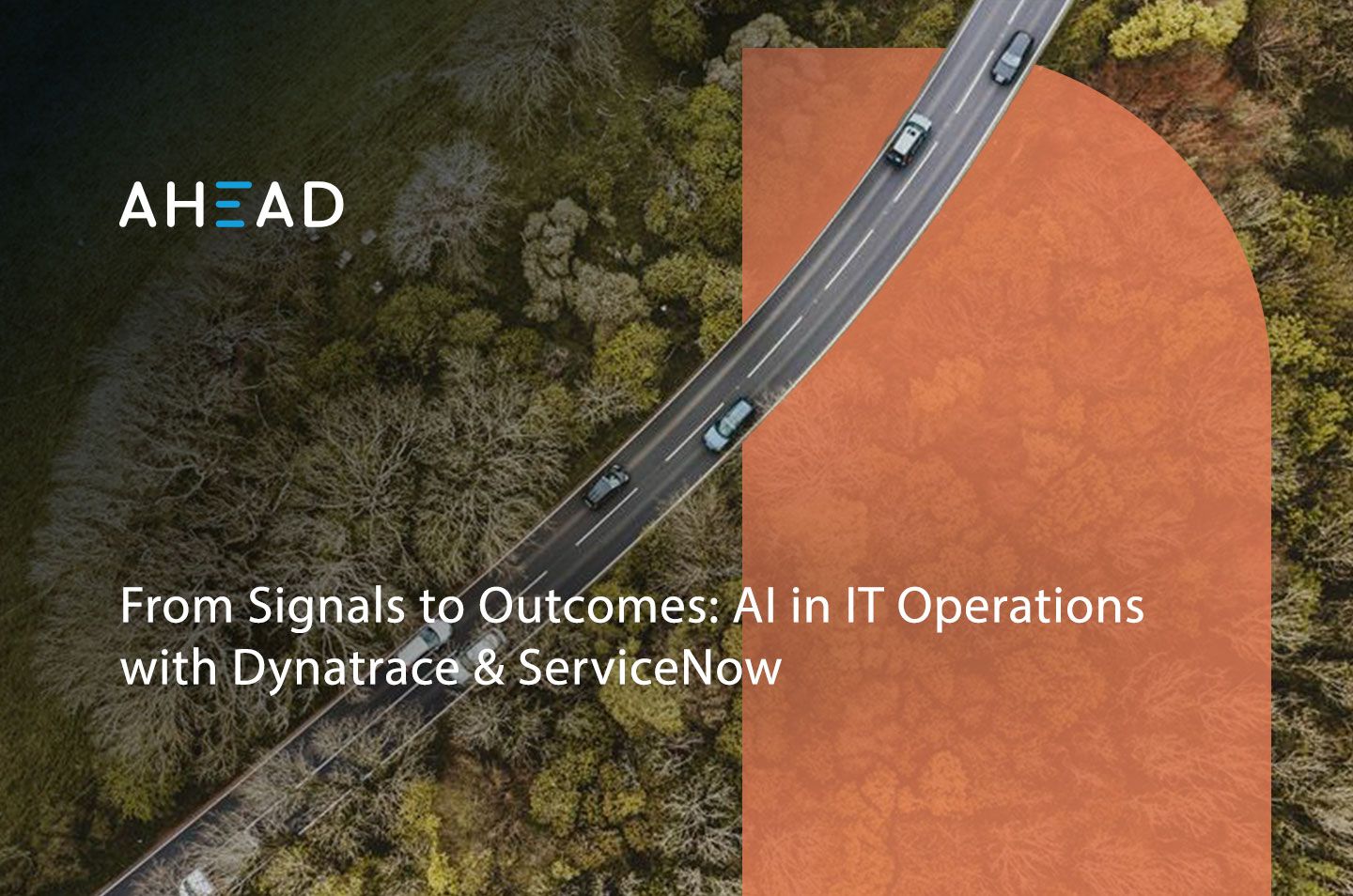 an arial view of a road cutting through a forest